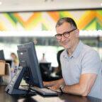 Owner of Birds Barbershop using barbershop software to run his business