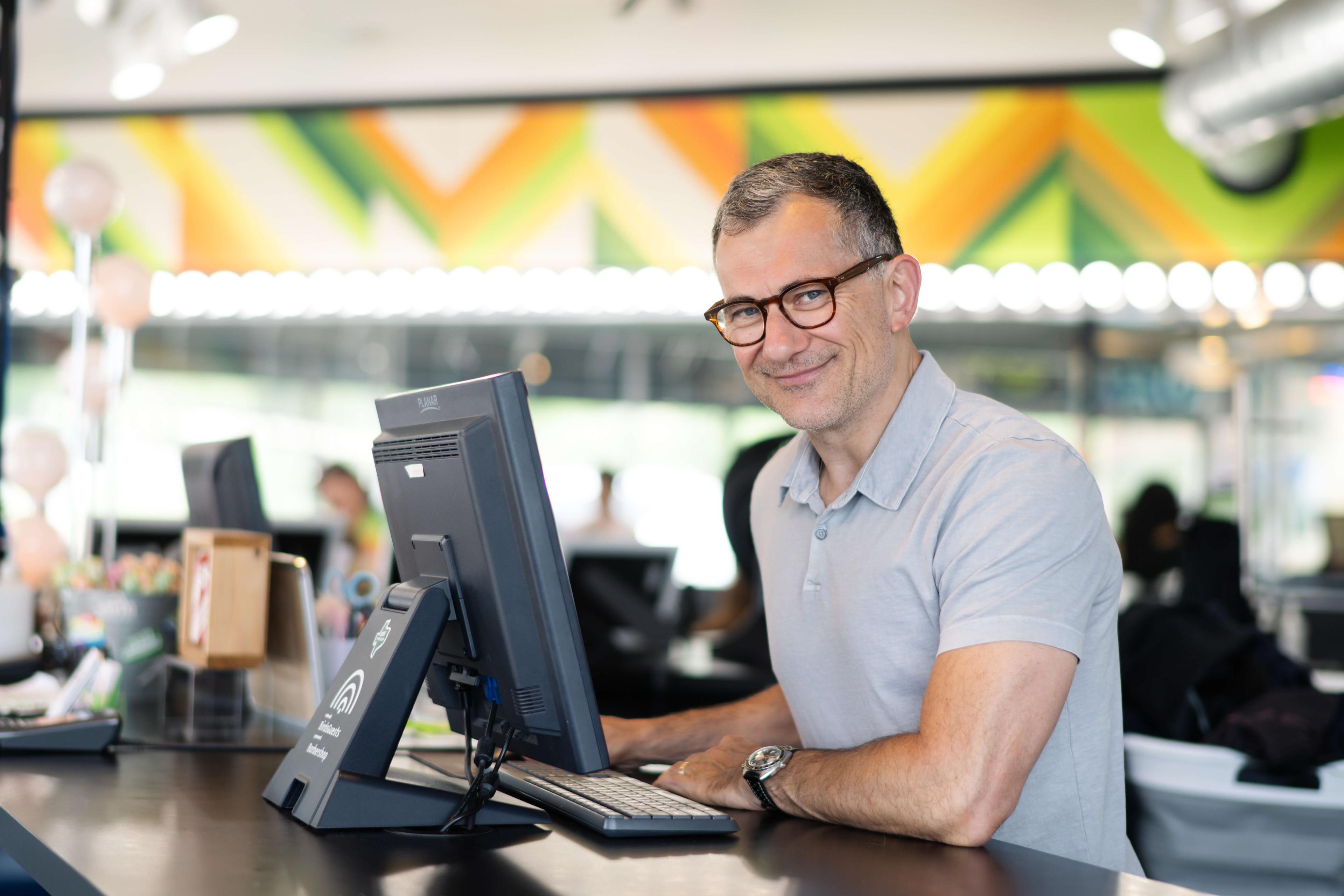 Owner of Birds Barbershop using barbershop software to run his business