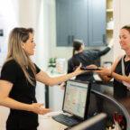 Spa staff member at front desk with guests