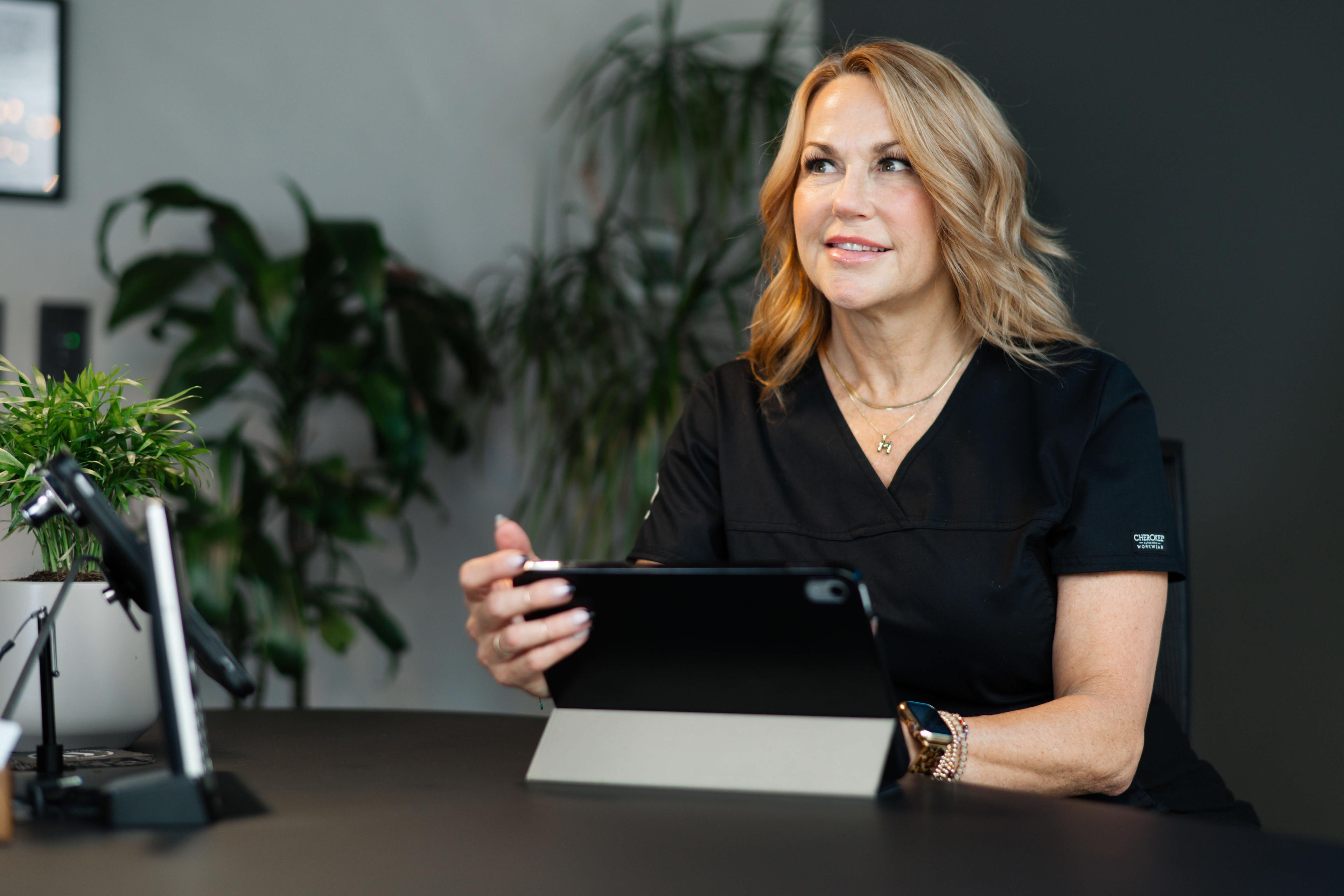 Spa business owner with plants representing the power change in business growth