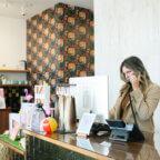 Salon front desk owner preparing to use an AI receptionist