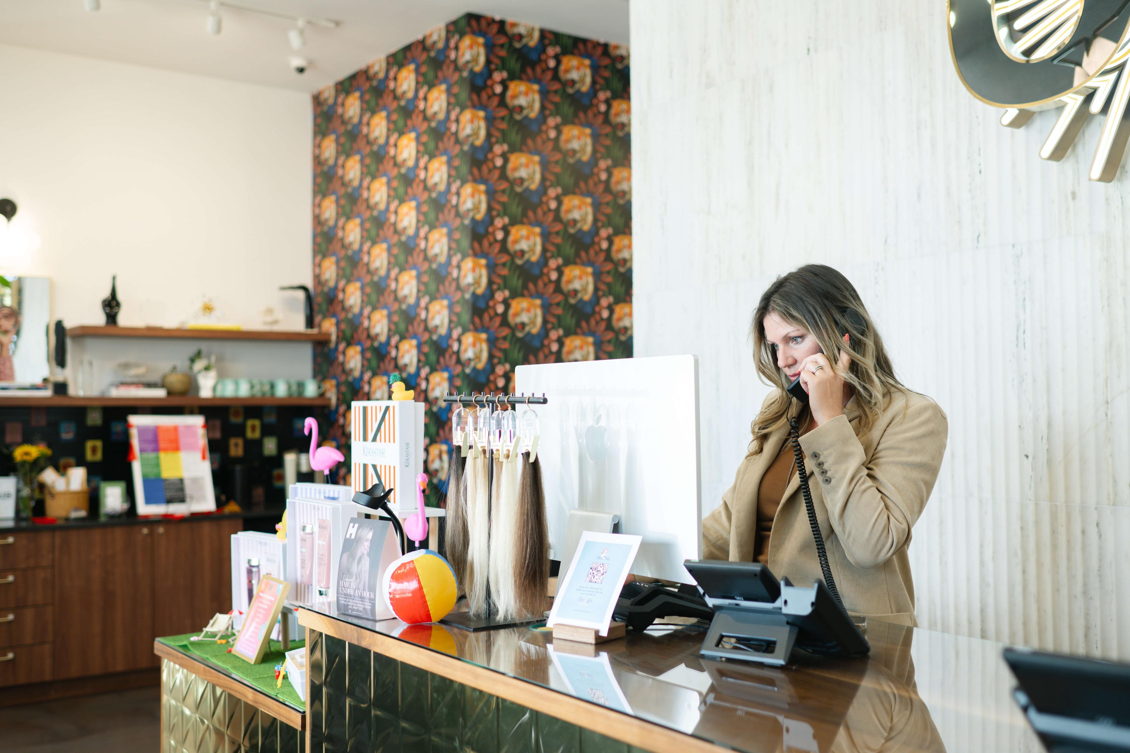 Salon front desk owner preparing to use an AI receptionist