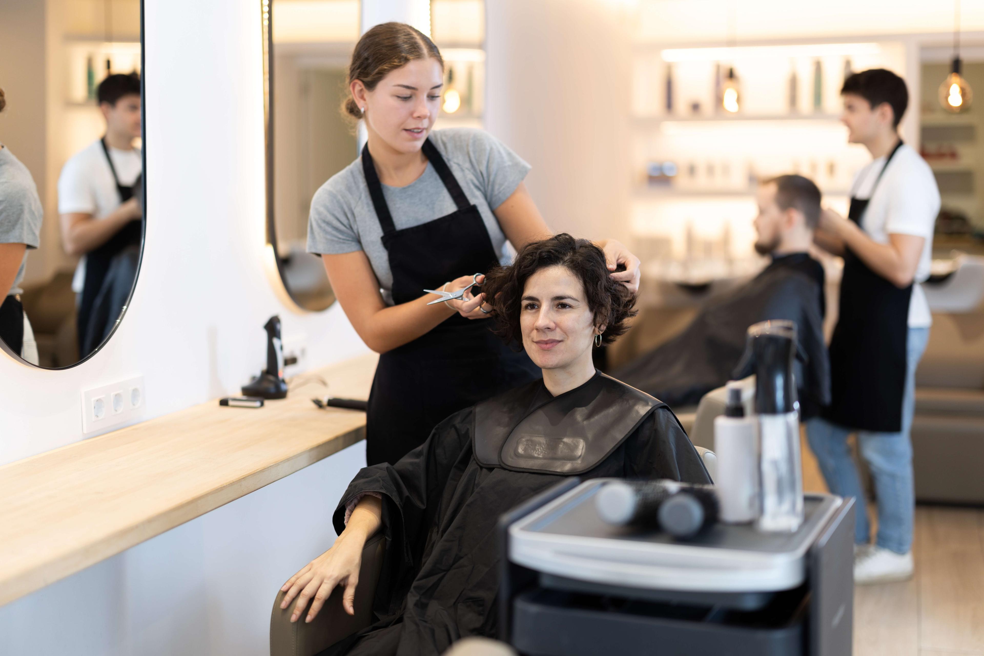 Hairdresser giving her client a fall hair refresh