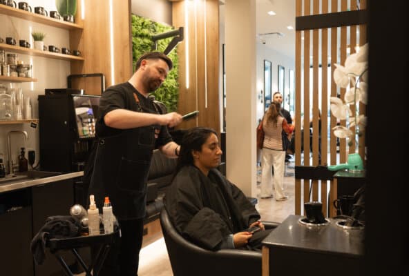 Hairstylist providing professional hair service for client in a modern salon