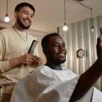 Barber and loyal customer smiling after appointment