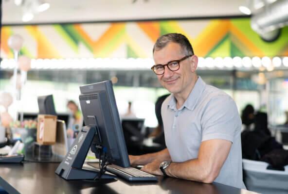 Owner of Birds Barbershop using barbershop software to run his business