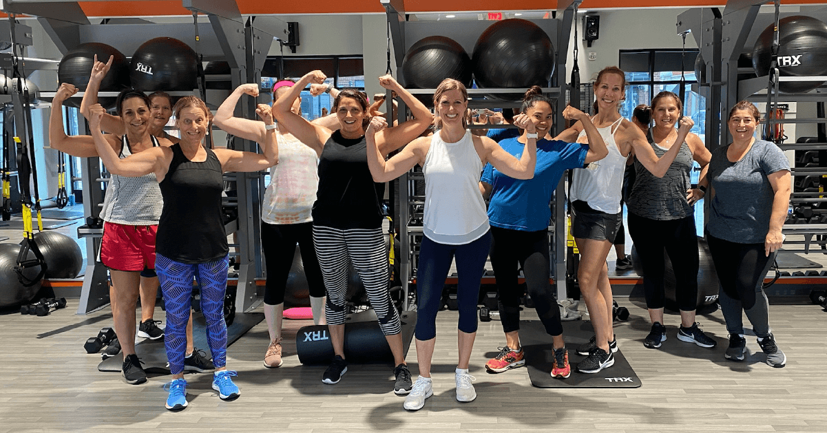 Strength students and instructors pose after class for a group shot in the InCycle gym.