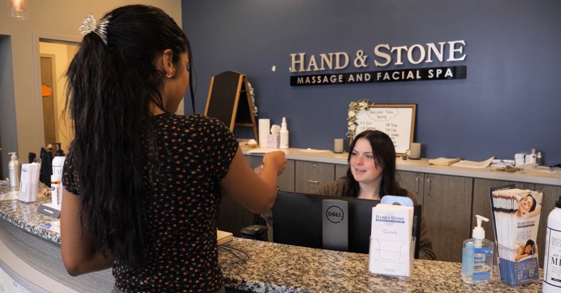 Hand & Stone front desk - customer talking to the receptionist