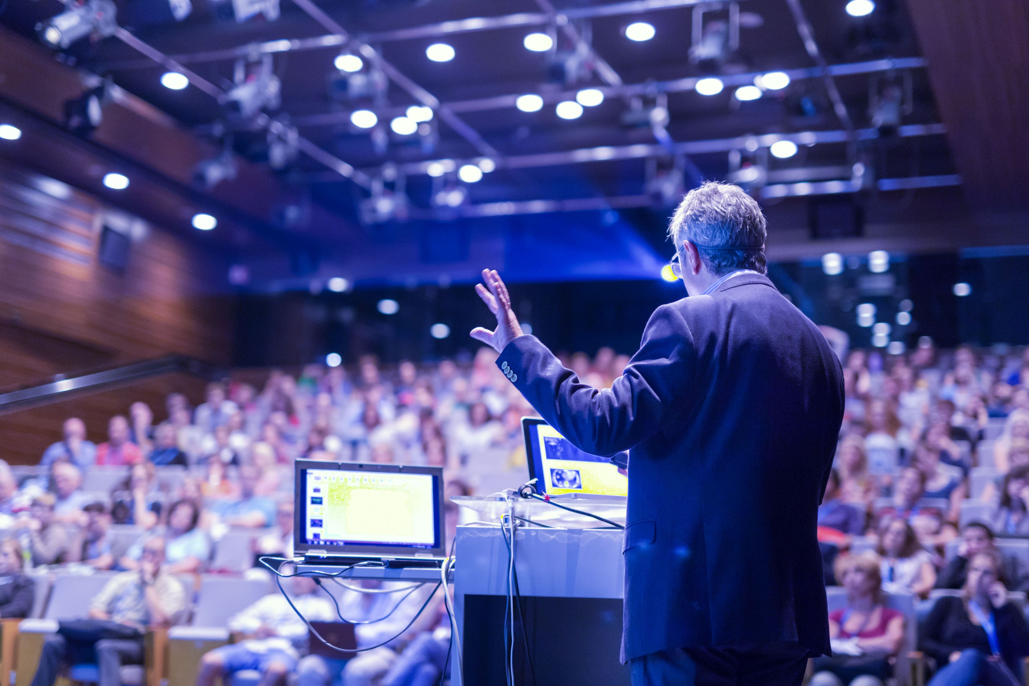 Speaker image talking at a summit