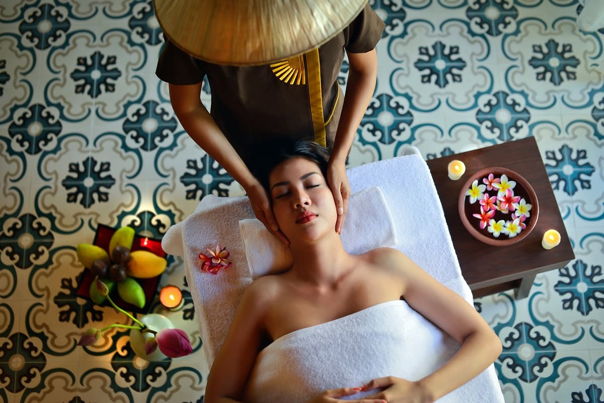 A spa member enjoys a soothing facial and massage in an exotic background. Source: The Anam on Unsplash for Zenoti, October 21, 2022 blog post. 