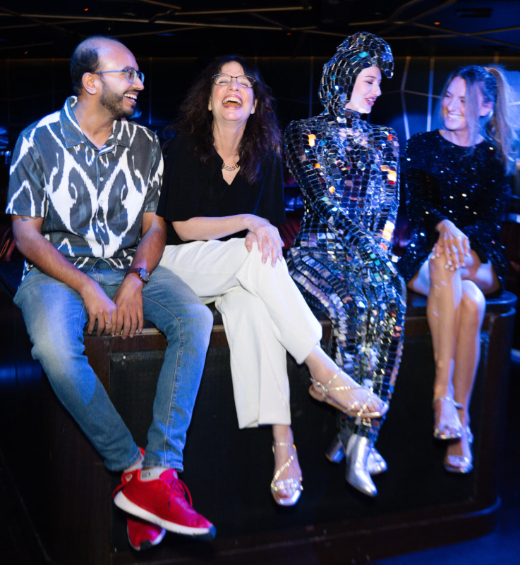 A group of people sitting on a stageAI-generated content may be incorrect., Picture