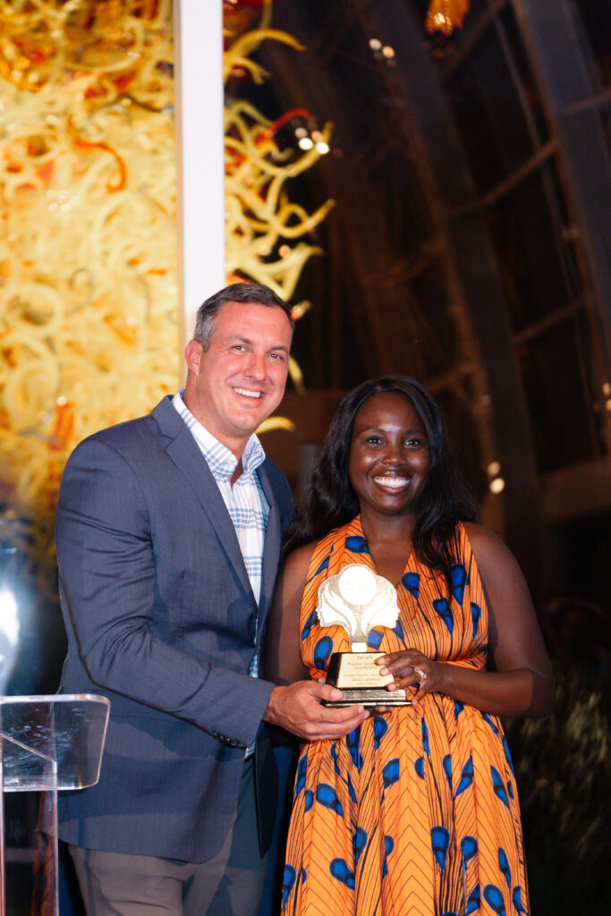 Bare Skin Waxing owner Kassy Stout accepting the award on Alexis Valentine's behalf; Zenoti's chief customer officer Steve Hudek presenting.