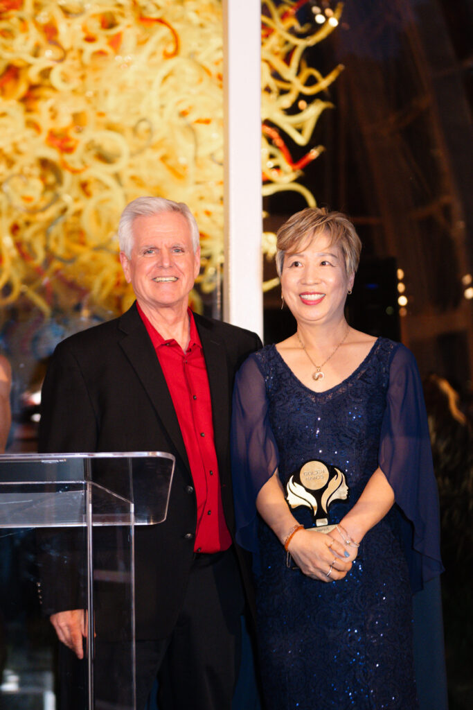 Senior VP and CTO of Hair Cuttery, Tim Lemieux, celebrating Hailey Han, quick-service salon stylist of the year, 